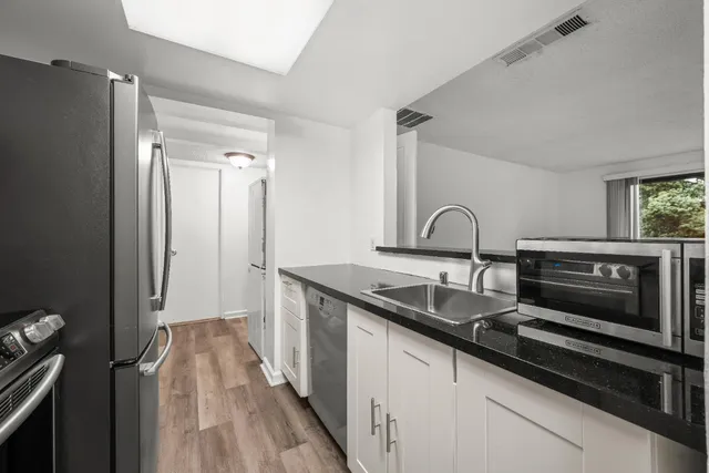 a kitchen with a sink and a refrigerator