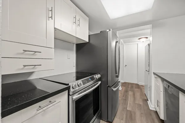 a kitchen with granite countertop a stove and a refrigerator