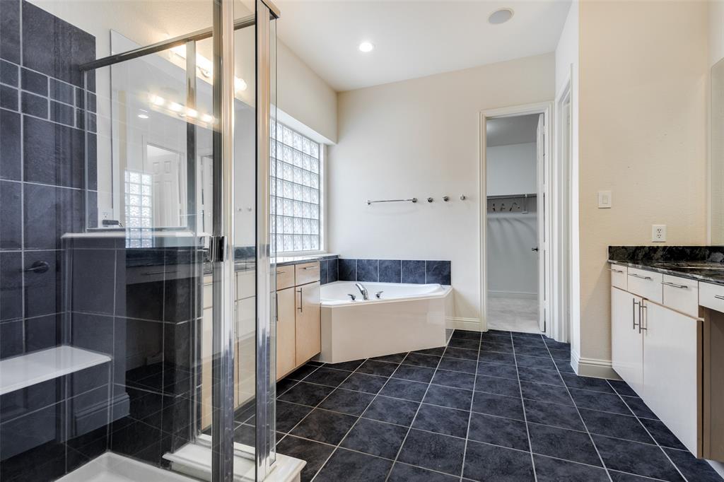 3313 Madison Avenue Hurst, TX 76054 - Photo 22 of 36 Primary Bathroom featuring tile patterned floors, separate shower and jetted tub, and vanity