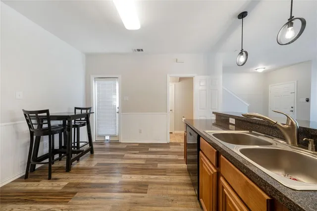 a kitchen that has a sink and cabinets