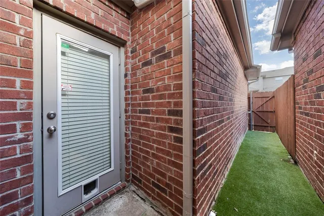 a view of a brick wall in front of a building