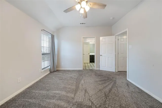 an empty room with windows and entrance