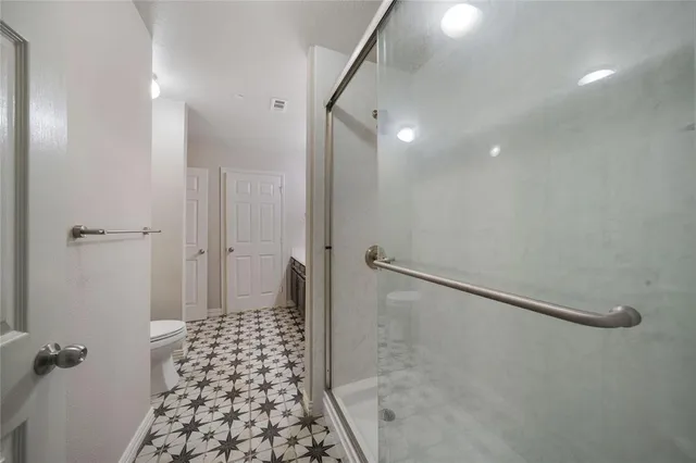 a bathroom with a glass door shower