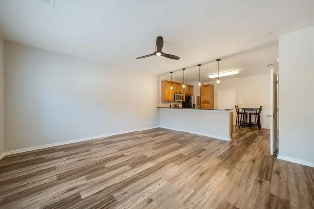 a view of a kitchen with a dishwasher and wooden floor