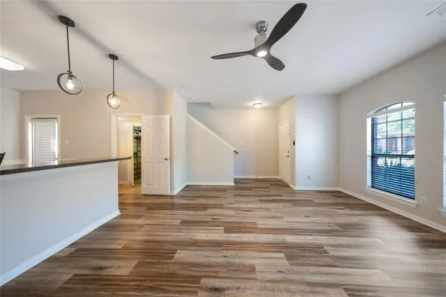 a view of a livingroom with a ceiling fan and window