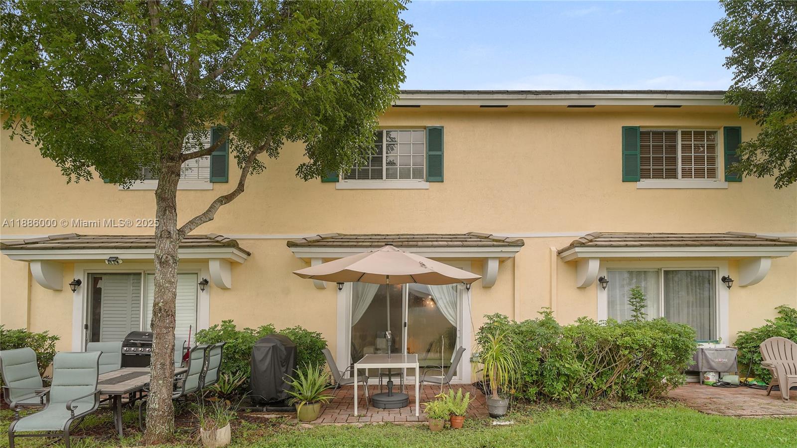 7717 Paddock Place Davie, FL 33328 - Photo 11 of 11 a view of a building with many windows and a table and chairs