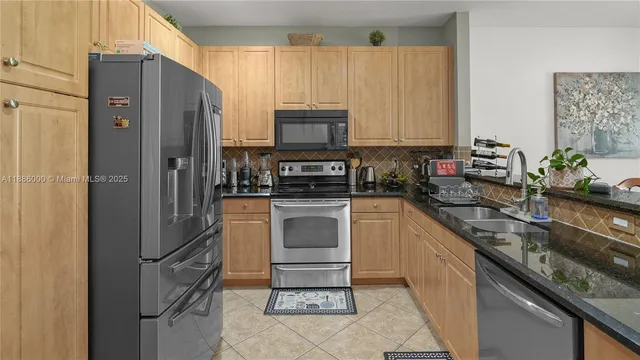 a kitchen with a refrigerator sink and stove