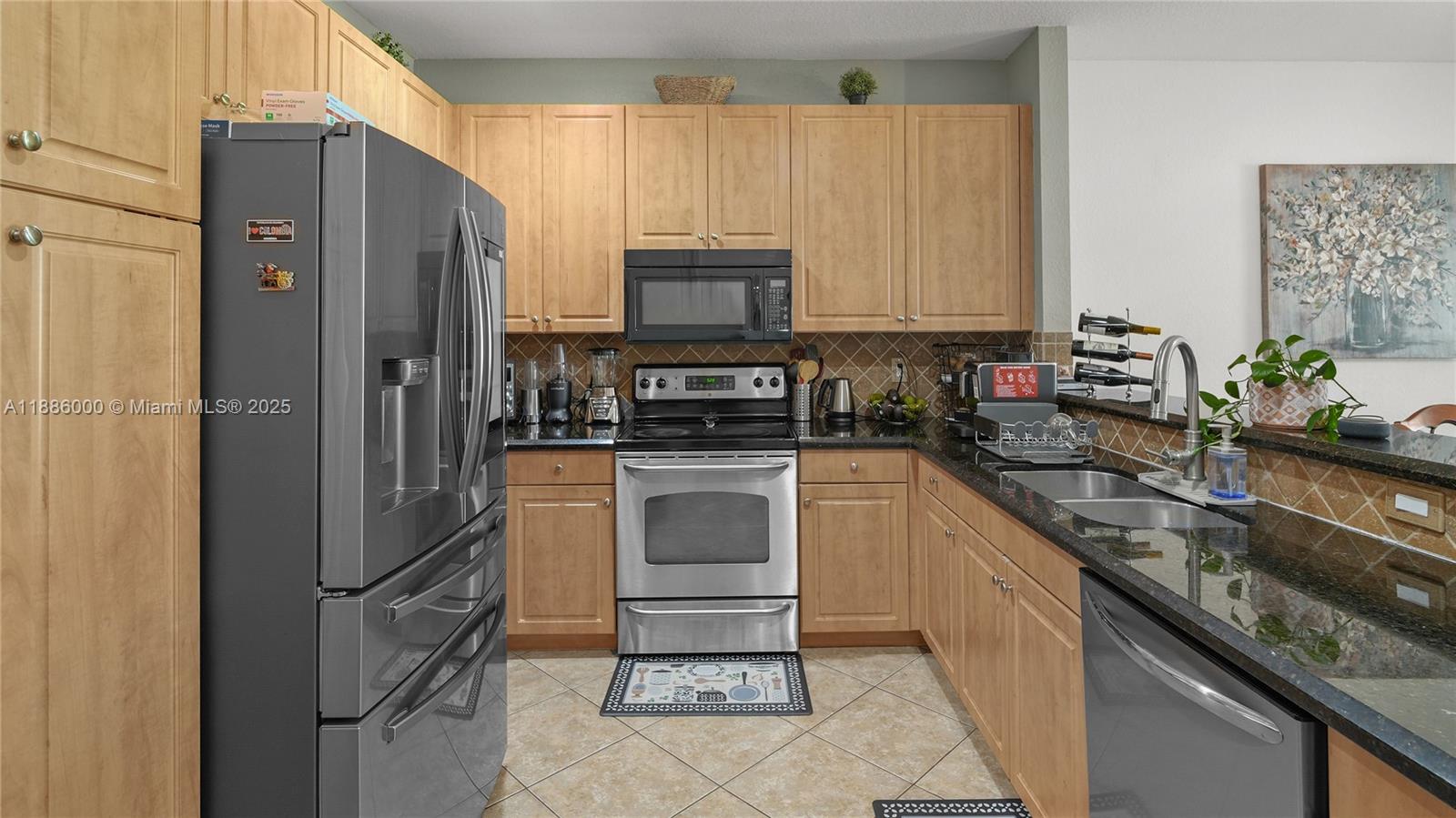 7717 Paddock Place Davie, FL 33328 - Photo 3 of 11 a kitchen with a refrigerator sink and stove