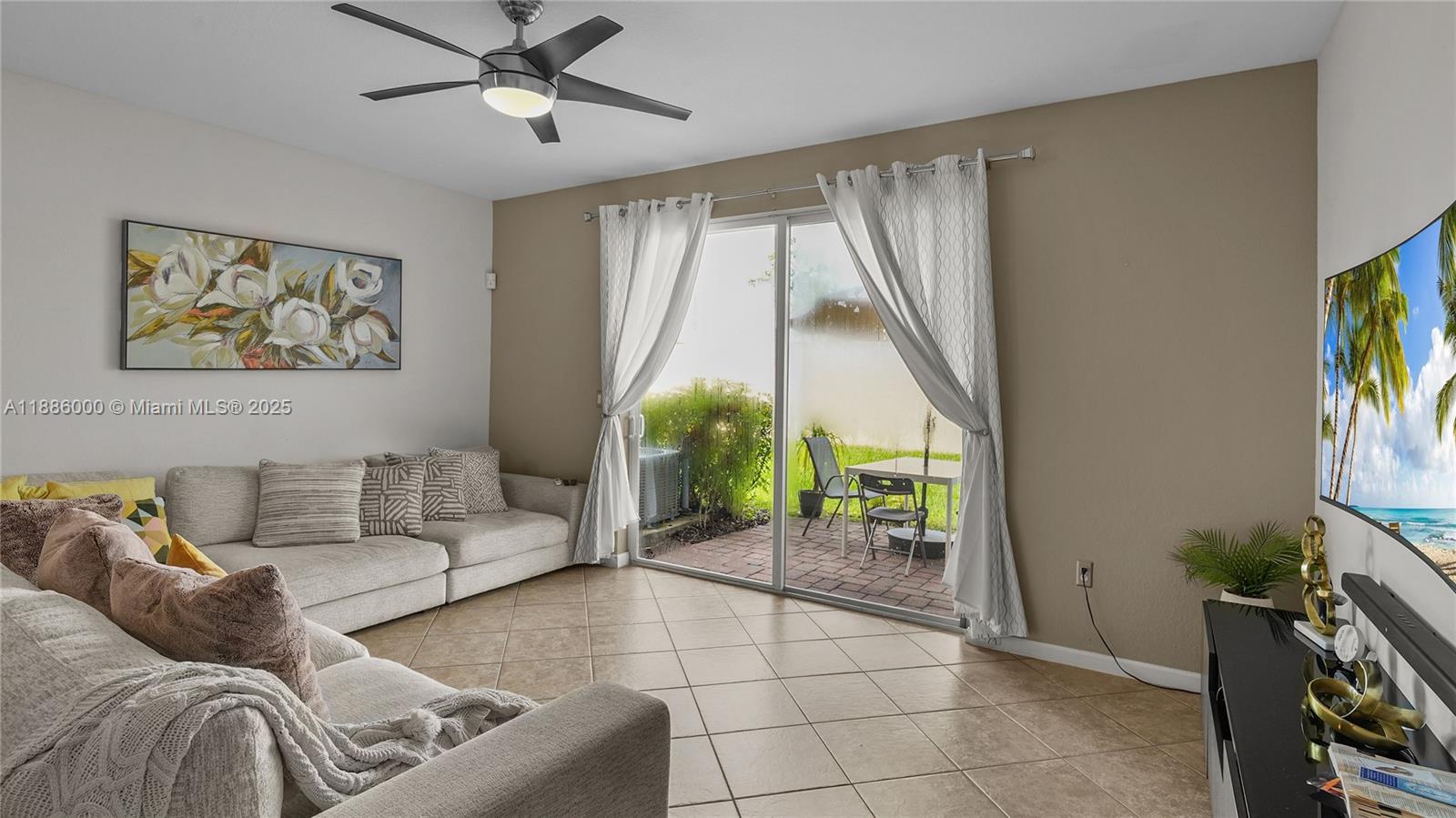 7717 Paddock Place Davie, FL 33328 - Photo 4 of 11 a living room with furniture and a large window