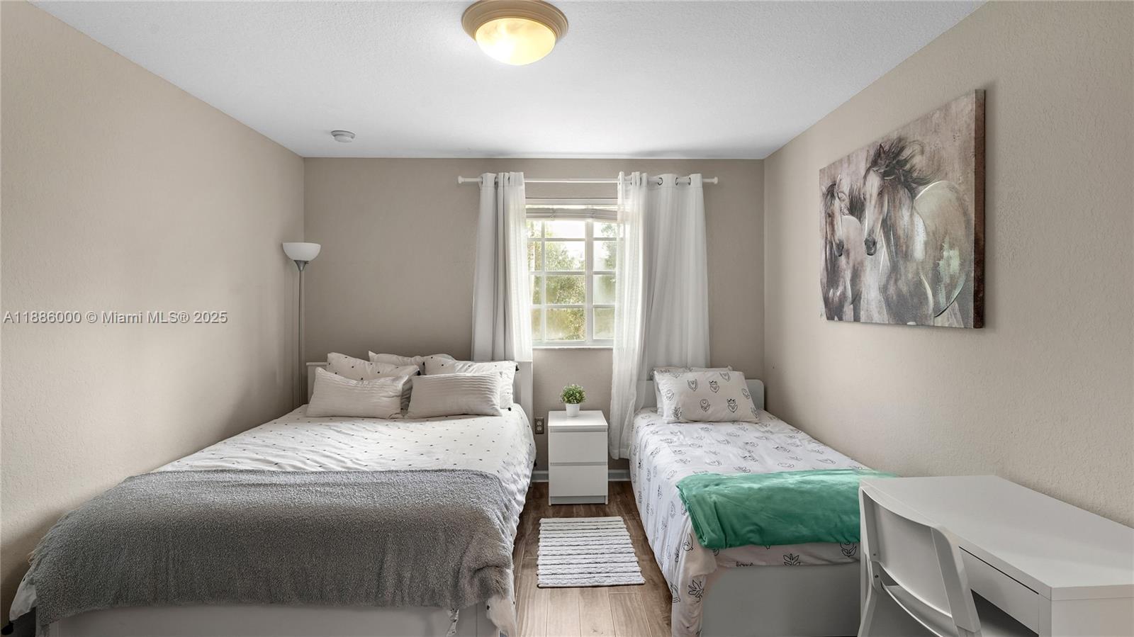 7717 Paddock Place Davie, FL 33328 - Photo 6 of 11 a bedroom with a two bed and a window