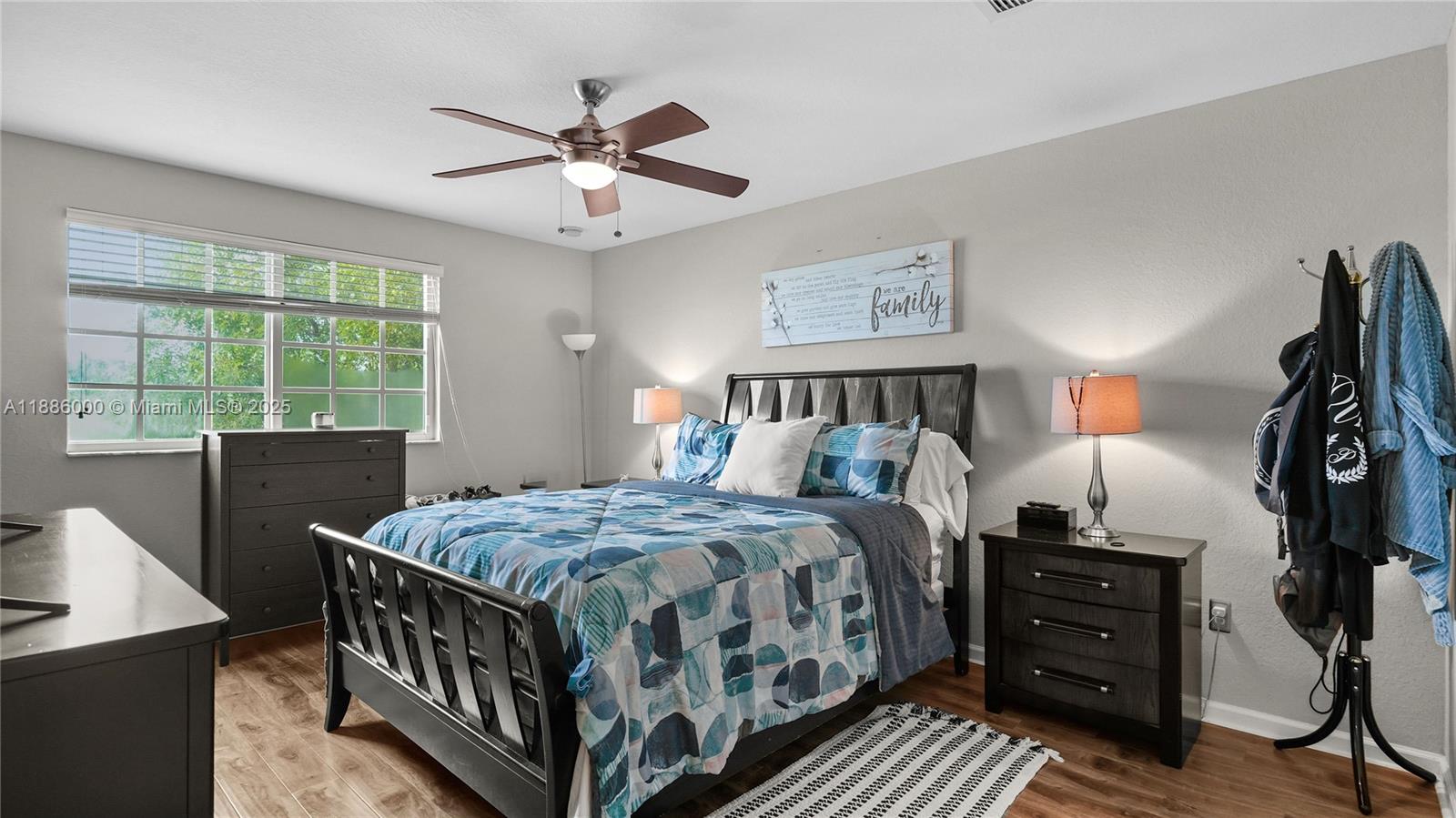 7717 Paddock Place Davie, FL 33328 - Photo 8 of 11 a bedroom with a bed and a window