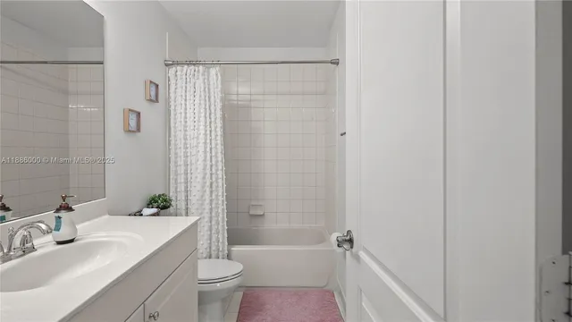 a bathroom with a bathtub shower sink vanity and toilet