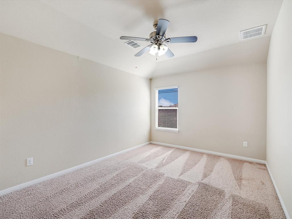 141 Serrano Street Georgetown, TX 78628 - Photo 16 of 19 An inviting room with plush carpeting offers a peaceful retreat for rest or study.