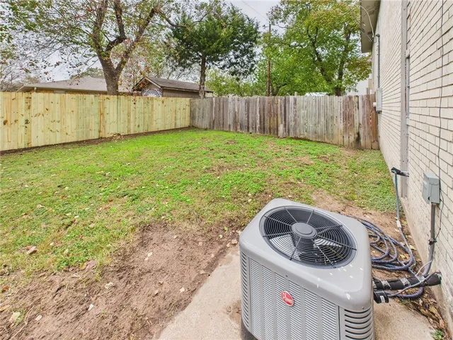 a utility room with wooden fence and trees