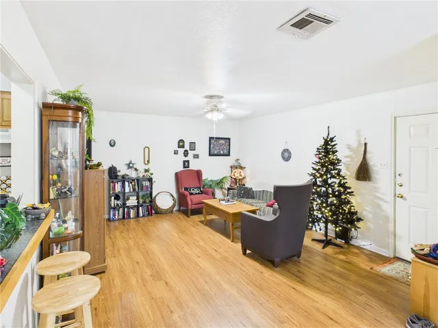 a living room with furniture stairs and a potted plant