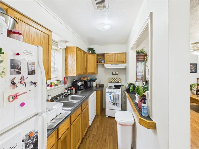 a kitchen with a sink stove and refrigerator
