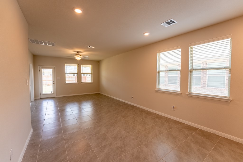 6310 Wolf Pack Drive Pflugerville, TX 78660 - Photo 13 of 34 a view of empty room with wooden floor and fan