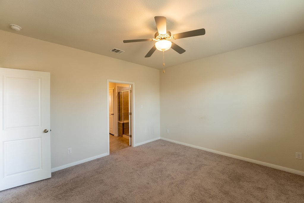 6310 Wolf Pack Drive Pflugerville, TX 78660 - Photo 17 of 34 an empty room with closet and a chandelier fan