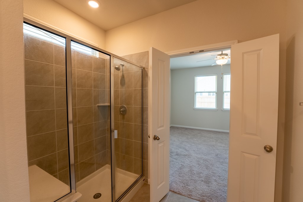6310 Wolf Pack Drive Pflugerville, TX 78660 - Photo 20 of 34 a bathroom with a shower and a sink