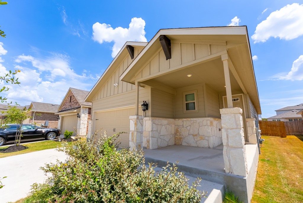 6310 Wolf Pack Drive Pflugerville, TX 78660 - Photo 2 of 34 a front view of a house with a yard