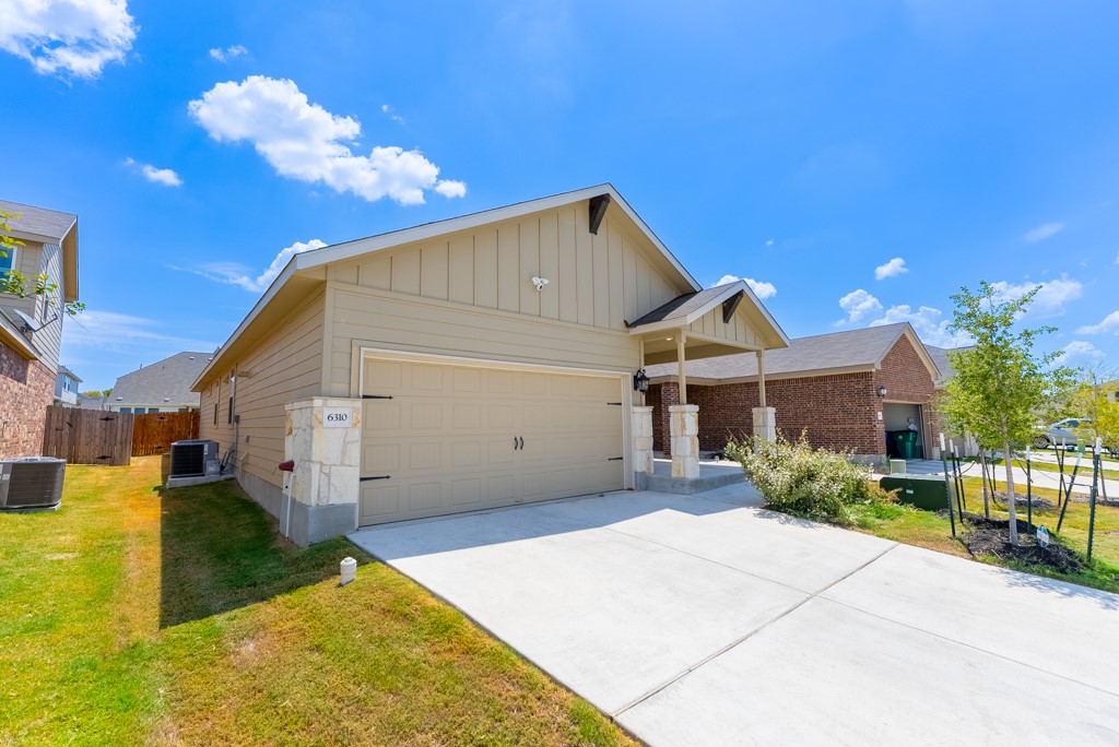 6310 Wolf Pack Drive Pflugerville, TX 78660 - Photo 2 of 33 a view of a house with a yard