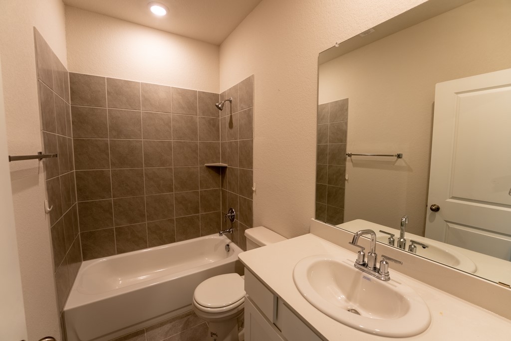 6310 Wolf Pack Drive Pflugerville, TX 78660 - Photo 21 of 34 a bathroom with a sink a toilet and bathtub