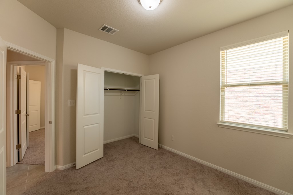 6310 Wolf Pack Drive Pflugerville, TX 78660 - Photo 23 of 34 a view of an empty room with a window