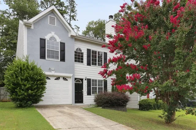 a front view of a house with a yard