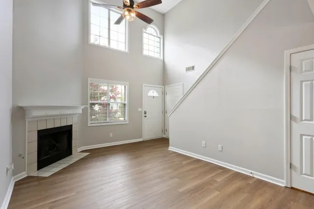 a view of empty room with wooden floor and fireplace