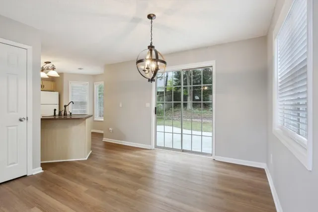 a view of a room with wooden floor and windows