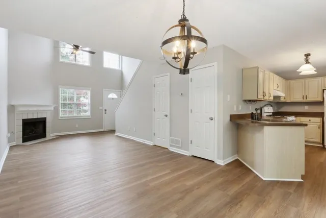 a view of empty room with wooden floor and fireplace