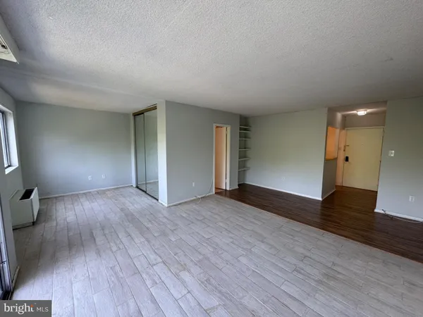 a view of a room with wooden floor and large window