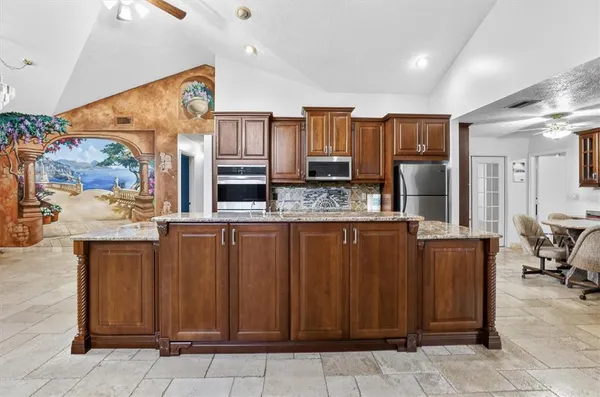 a kitchen with stainless steel appliances a refrigerator and microwave
