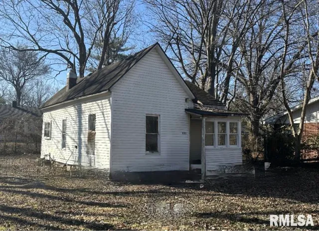 a front view of a house with trees
