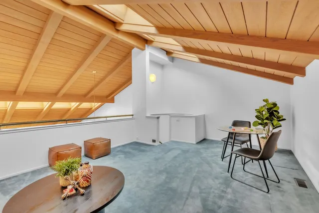 a bedroom with a bed and a potted plant