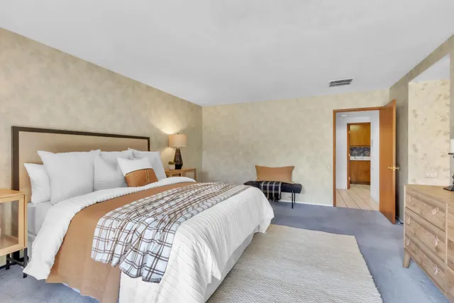 a bathroom with a bathtub and next to a window