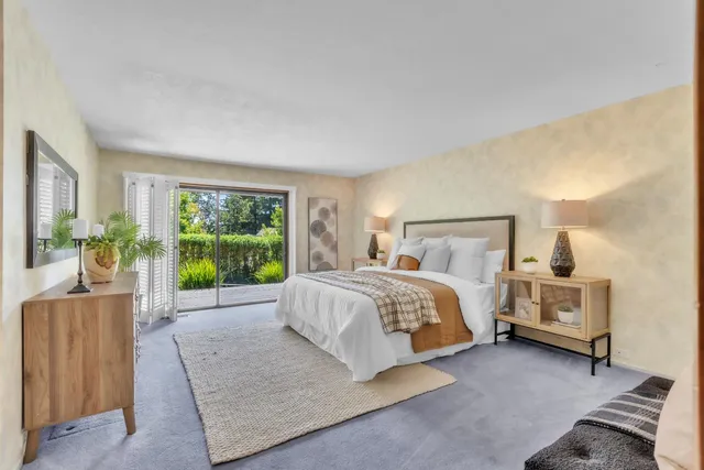 a bedroom with bed and a a mirror