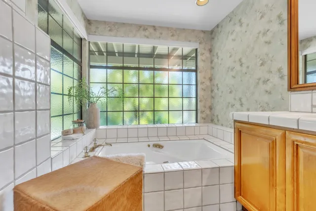 a bathroom with a sink a toilet and a mirror