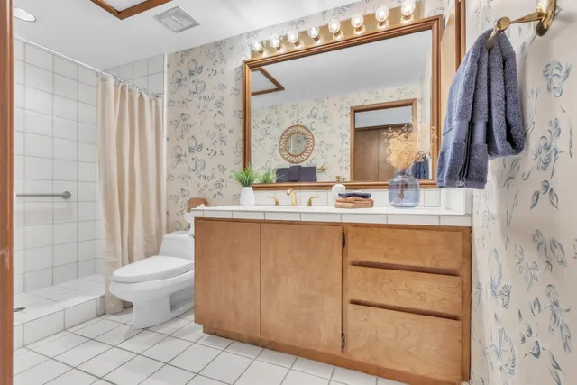 a view of a patio with couches table and chairs and potted plants