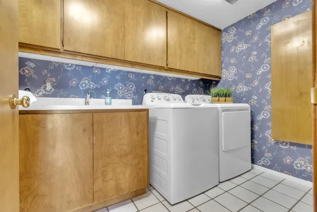 a view of a house with a yard and potted plants