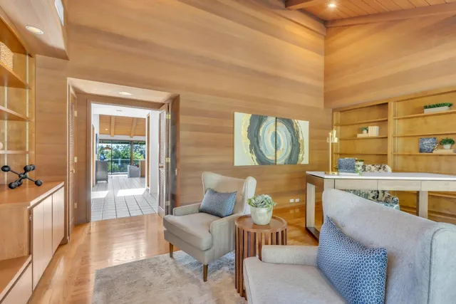 a view of a dining room with furniture a chandelier and wooden floor