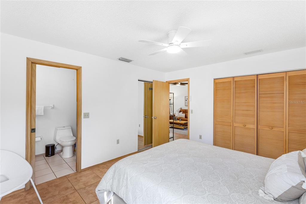 4537 South Lockwood Ridge Road Sarasota, FL 34231 - Photo 12 of 22 a bedroom with a bed and a dresser