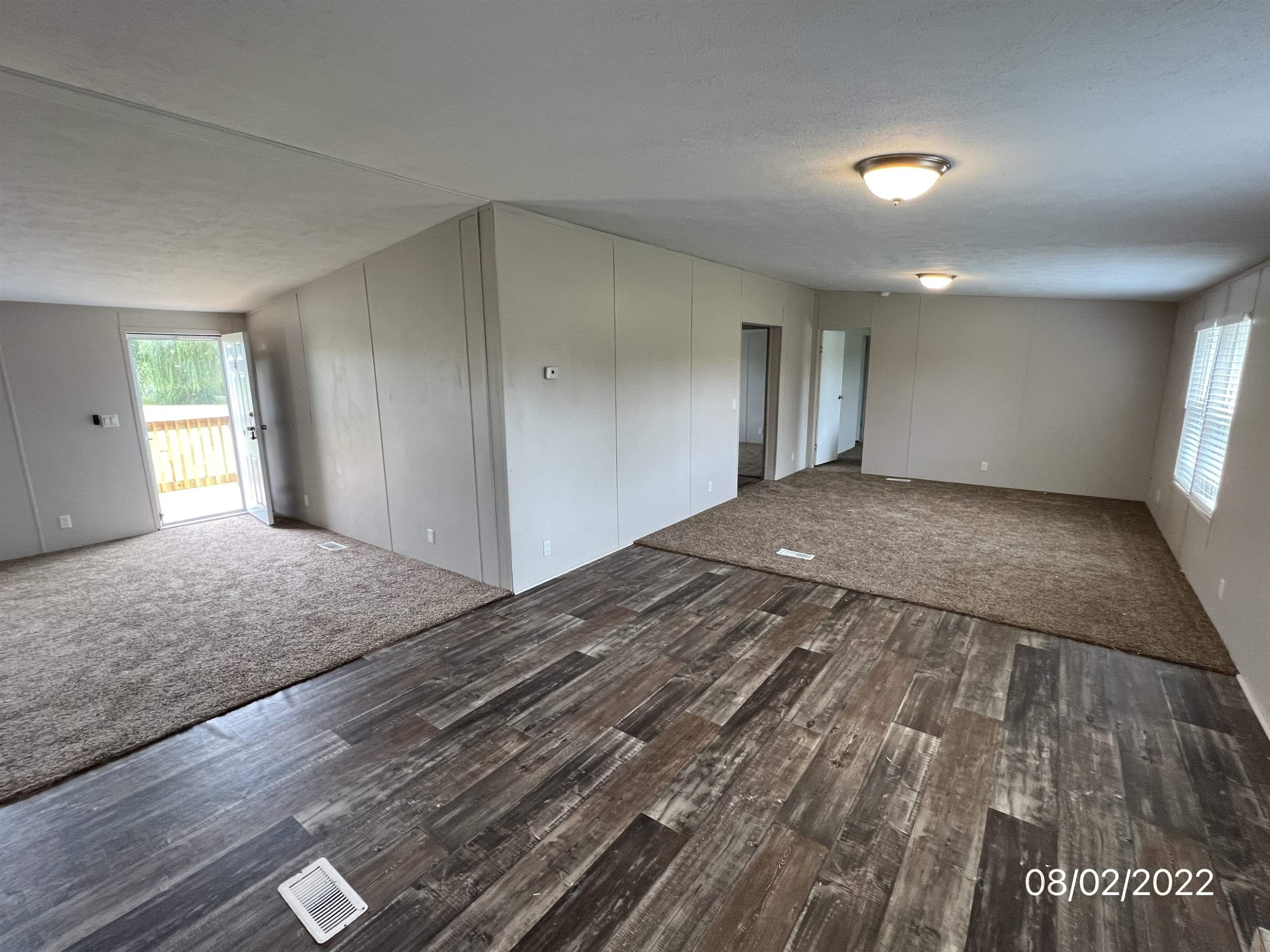 598 Key Road Troy, TN 38260 - Photo 11 of 25 a view of a big room with wooden floor and windows