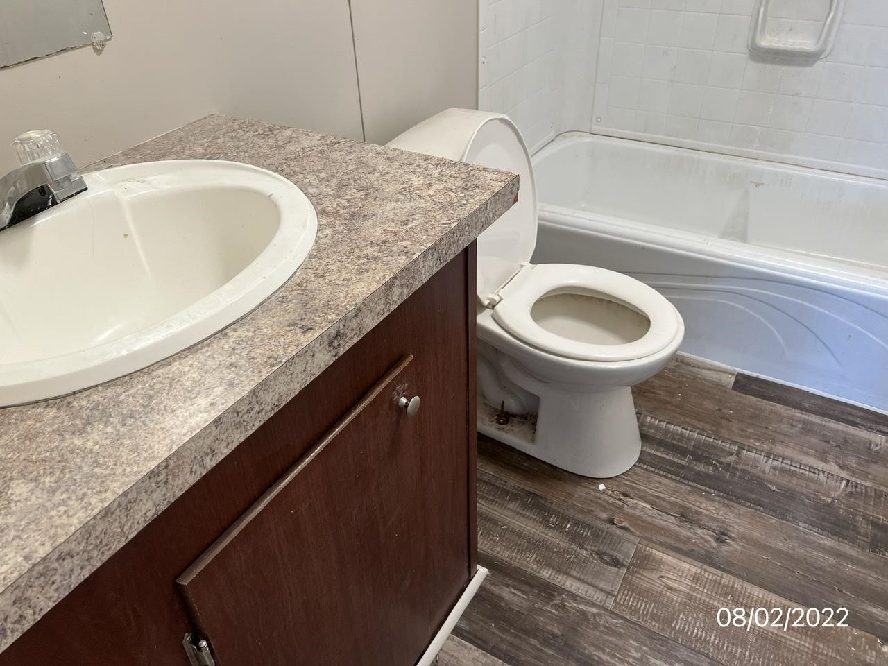 598 Key Road Troy, TN 38260 - Photo 14 of 25 a bathroom with a granite countertop sink and a toilet