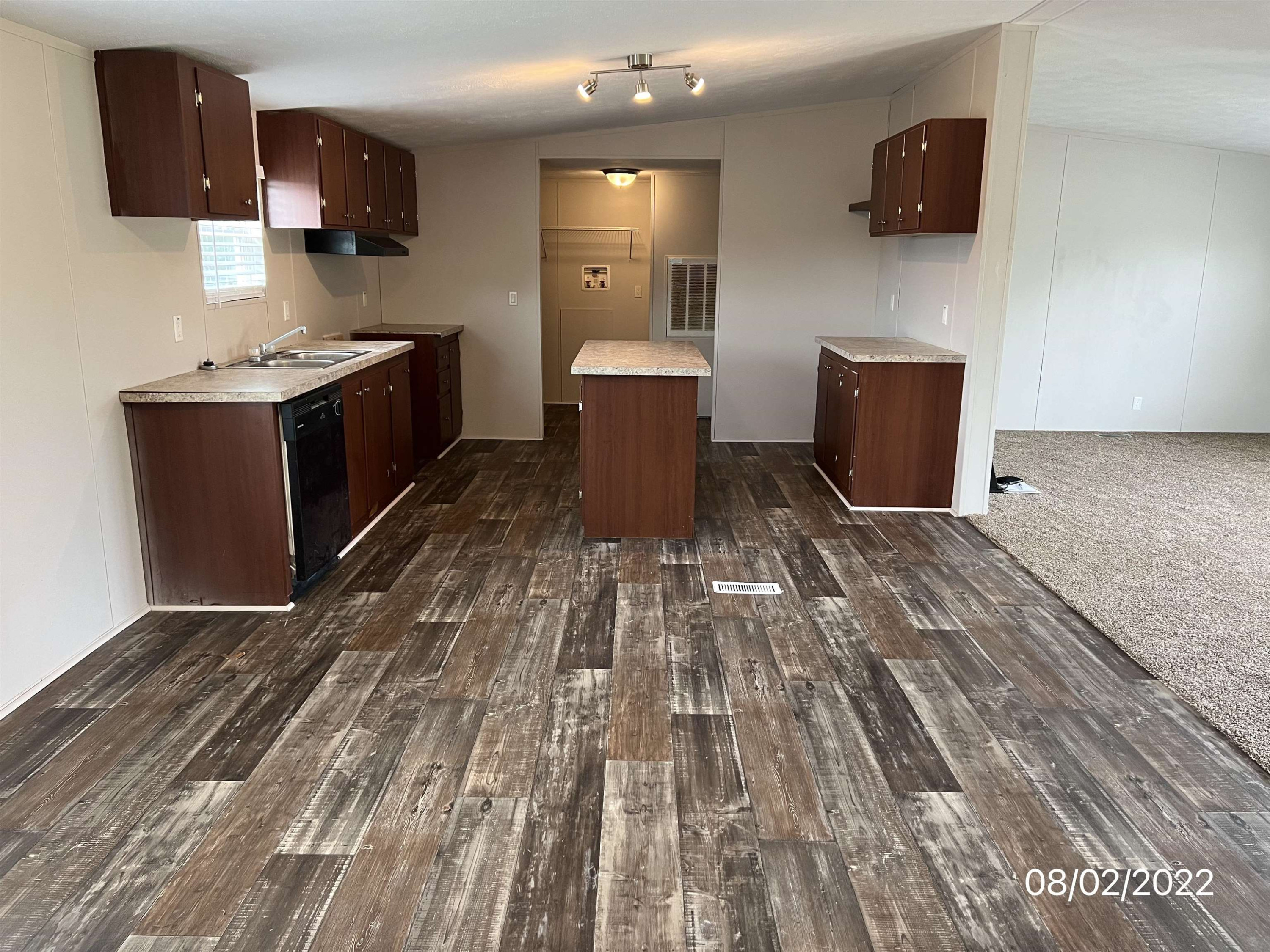 598 Key Road Troy, TN 38260 - Photo 7 of 25 a living room with stainless steel appliances furniture a flat screen tv and a wooden floor