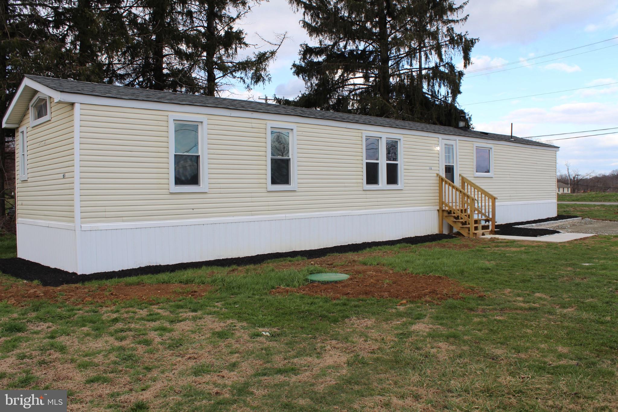 Charming mobile home with inviting entry.