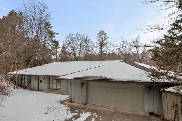 a view of a house with a snow in the yard