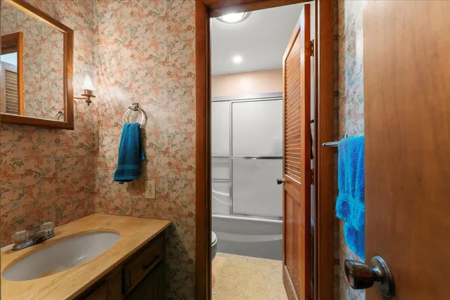 a bathroom with a shower and a sink