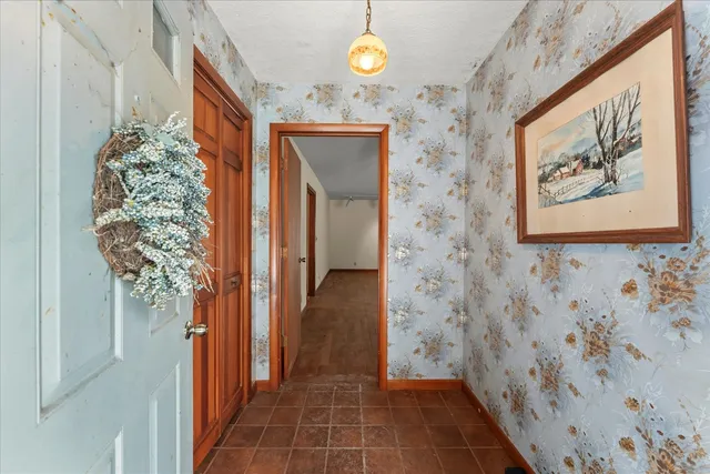 a view of an empty room and window and wooden floor