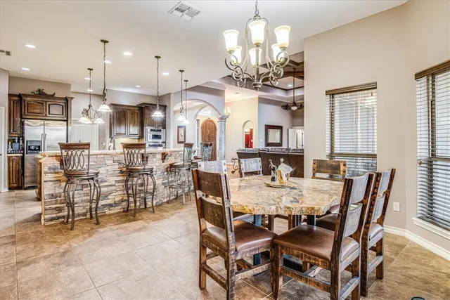 a view of a dining room with furniture and a chandelier